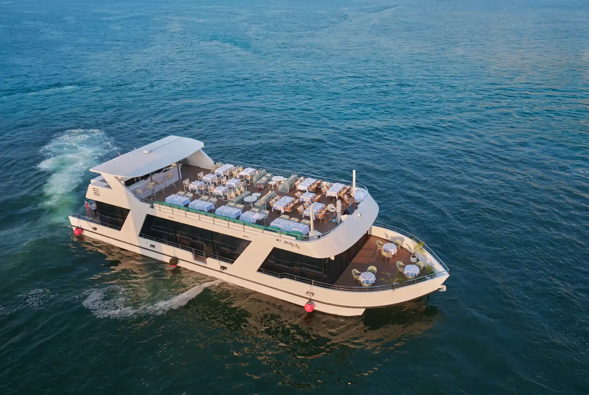 Aerial view of a Noble Life luxury yacht cruising the Arabian Gulf in Dubai